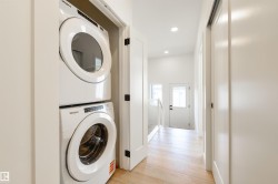 Integrated stacked laundry appliances within a hallway closet - 