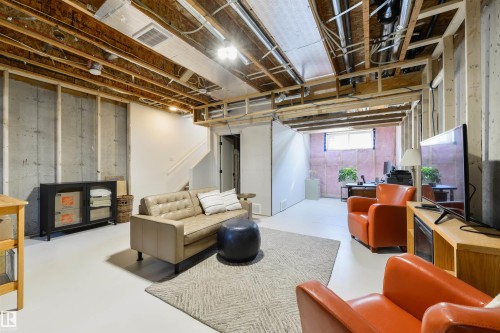 Spacious unfinished basement offering concrete foundation walls, exposed overhead joists, and a painted concrete floor - 323 Rankin Drive, St. Albert, AB - Indoor Photo Showing Basement