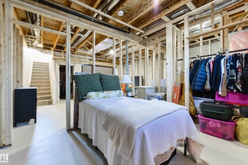 Unfinished basement featuring visible wood framing, exposed ceiling joists, and concrete flooring - 323 Rankin Drive, St. Albert, AB - Indoor Photo Showing Other Room