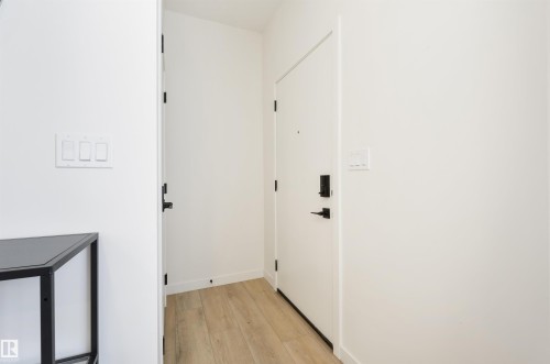Entryway featuring wood-finish flooring and crisp white walls - 323 Rankin Drive, St. Albert, AB - Indoor Photo Showing Other Room