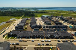 New residential development featuring a variety of housing styles, paved streets, and a mix of single-family homes and townhomes - 
