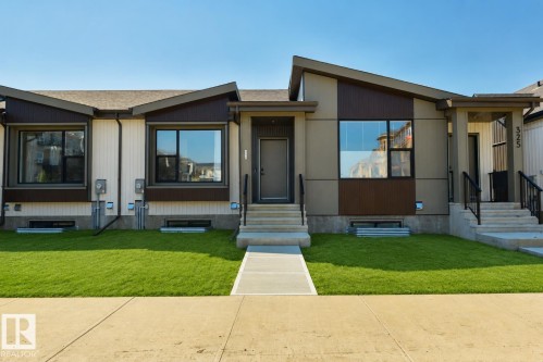 Modern facade featuring a mix of horizontal siding and paneling, with a prominent A-frame architectural element - 323 Rankin Drive, St. Albert, AB - Outdoor With Facade
