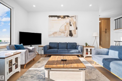 Expansive open-concept living area featuring tall ceilings and a large picture window - 12304 62 Ave Nw, Edmonton, AB - Indoor Photo Showing Living Room