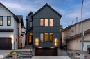 Contemporary dark-toned exterior with vertical panel siding, prominent gable roofline, integrated garage, and illuminated entryway - 12304 62 Ave Nw, Edmonton, AB  - Outdoor With Facade 