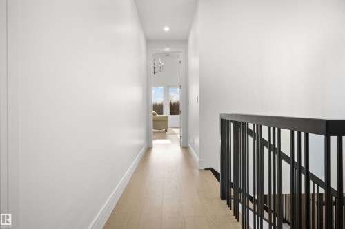 Hallway featuring light wood-finish flooring, white baseboards, and recessed lighting - 12304 62 Ave Nw, Edmonton, AB - Indoor Photo Showing Other Room