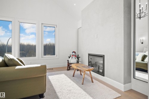 Vaulted ceiling with recessed lighting, three large windows, modern fireplace, and light wood-finish flooring - 12304 62 Ave Nw, Edmonton, AB - Indoor Photo Showing Living Room With Fireplace