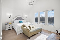 Bright bedroom with vaulted ceilings and a contemporary chandelier - 