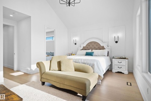 Spacious room with light wood-finish flooring, vaulted ceiling, and recessed lighting - 12304 62 Ave Nw, Edmonton, AB - Indoor Photo Showing Bedroom