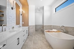 Dual vanity with undermount sinks and white countertops, featuring matte black hardware and polished chrome faucets - 