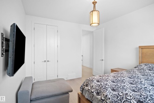 Recessed lighting, wood-finish flooring, and a contemporary ceiling fixture illuminate this space - 12304 62 Ave Nw, Edmonton, AB - Indoor Photo Showing Bedroom