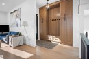 Built-in mudroom cabinetry with wood-finish paneling, integrated bench seating, and matte black hardware - 12304 62 Ave Nw, Edmonton, AB  - Indoor Photo Showing Other Room 