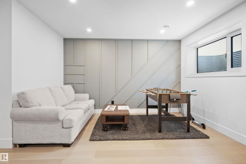 Bright room featuring light wood-finish flooring and recessed lighting - 12304 62 Ave Nw, Edmonton, AB - Indoor