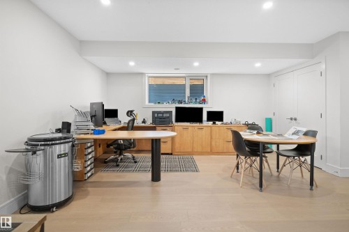 Expansive room featuring wood-finish flooring, recessed lighting, and a window with horizontal blinds - 12304 62 Ave Nw, Edmonton, AB - Indoor Photo Showing Office