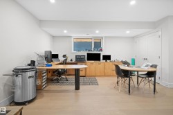 Expansive room featuring wood-finish flooring, recessed lighting, and a window with horizontal blinds - 