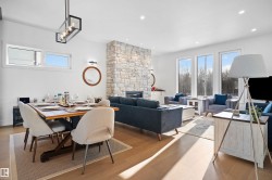 Open-concept living area with wood-finish flooring - 