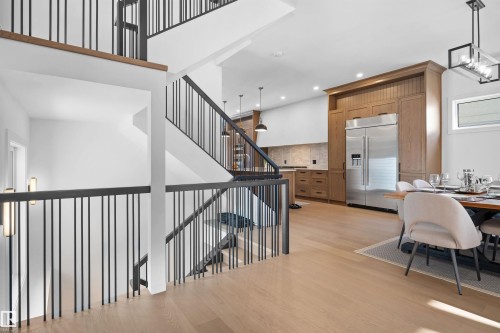 Open-concept living space with light wood-finish flooring - 12304 62 Ave Nw, Edmonton, AB - Indoor Photo Showing Other Room
