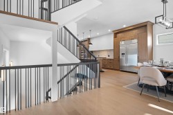 Open-concept living space with light wood-finish flooring - 