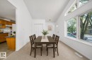Vaulted ceilings above a carpeted dining area featuring extensive natural light from a large window array - 12041/43 67 St Nw Nw, Edmonton, AB  - Indoor Photo Showing Dining Room 