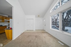 Vaulted ceiling living space with large windows and transom windows - 