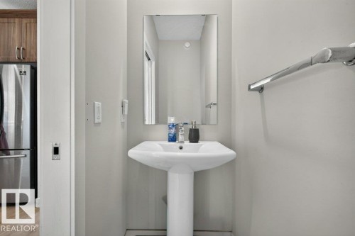 Pedestal sink with polished chrome faucet and coordinating towel bar - 43 Sienna Boulevard, Fort Saskatchewan, AB - Indoor Photo Showing Bathroom