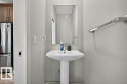 Pedestal sink with polished chrome faucet and coordinating towel bar - 