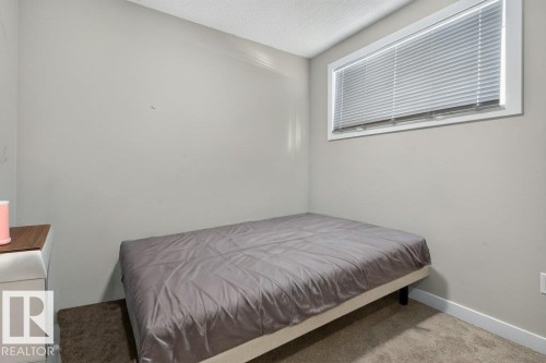 Carpeted room with a horizontal window featuring blinds - 43 Sienna Boulevard, Fort Saskatchewan, AB - Indoor Photo Showing Bedroom