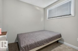 Carpeted room with a horizontal window featuring blinds - 