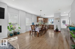 Expansive open concept living area featuring wood-finish flooring throughout - 