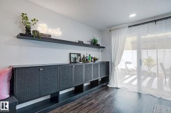 Built-in cabinetry with textured panel doors, integrated open shelving, and a floating wall shelf - 