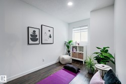 Room featuring dark wood-finish flooring, white walls, and a recessed ceiling light - 