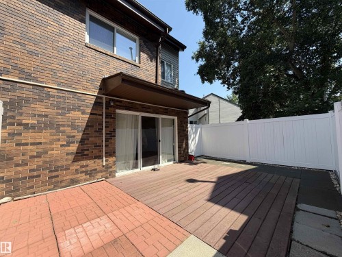 Expansive outdoor patio featuring a blend of brick pavers and composite decking - 19F Meadowlark Village Nw, Edmonton, AB - Outdoor With Deck Patio Veranda With Exterior