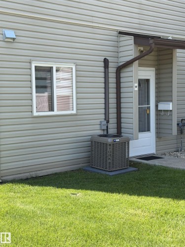 Exterior wall with horizontal siding, featuring a white-framed window and a brown downspout - 19F Meadowlark Village Nw, Edmonton, AB - Outdoor With Exterior