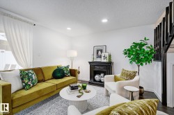 Living area with bright white walls, recessed ceiling lighting, and dark wood-finish flooring - 