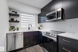 Contemporary kitchen featuring dark wood-finish cabinetry, white countertops, and a white tiled backsplash - 