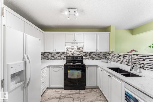 Updated ceramic tile, countertop and backplash. - 13148 151 Avenue Nw, Edmonton, AB - Indoor Photo Showing Kitchen With Double Sink With Upgraded Kitchen