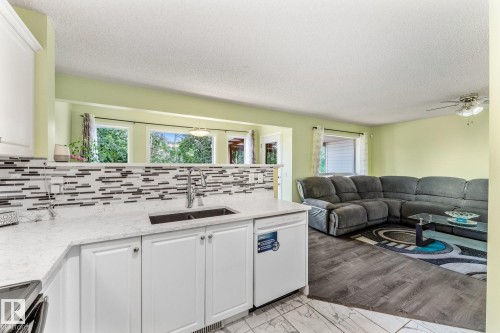 View from the kitchen looking into the living room and dining area. - 13148 151 Avenue Nw, Edmonton, AB - Indoor