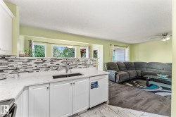 View from the kitchen looking into the living room and dining area. - 