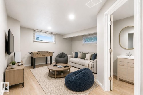 Virtually staged basement rec room with 3 piece bathroom - 13148 151 Avenue Nw, Edmonton, AB - Indoor Photo Showing Basement