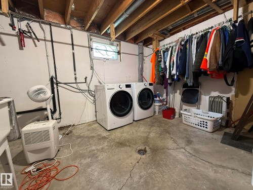 Basement utility area featuring exposed wood joists and a concrete floor - 10837 155 Street Nw, Edmonton, AB - Indoor Photo Showing Laundry Room