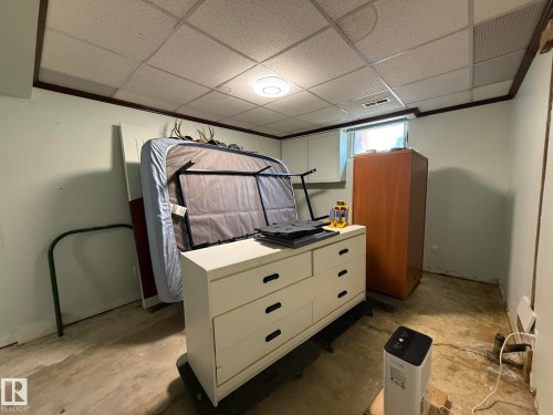 Basement room featuring a drop ceiling with recessed lighting, painted walls, and a visible window opening - 10837 155 Street Nw, Edmonton, AB - Indoor