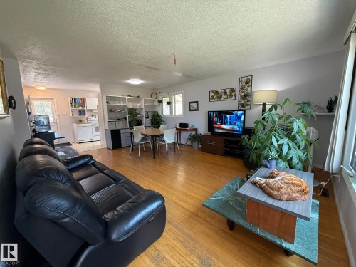 Open-concept living space featuring wood-finish flooring throughout - 10837 155 Street Nw, Edmonton, AB - Indoor Photo Showing Living Room