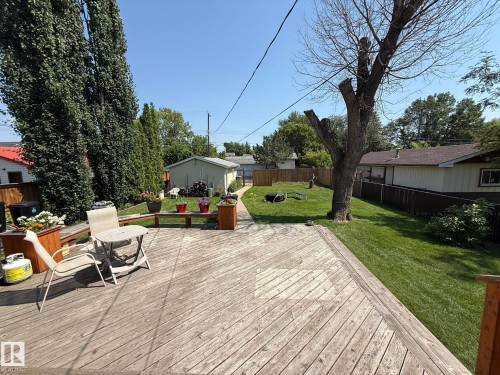 Spacious wood deck extending to a manicured lawn - 10837 155 Street Nw, Edmonton, AB - Outdoor With Deck Patio Veranda