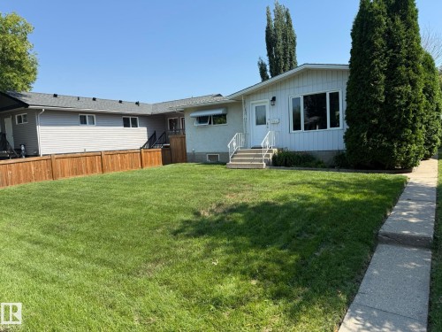 Single-story residence featuring white siding and a concrete walkway - 10837 155 Street Nw, Edmonton, AB - Outdoor