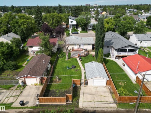 Spacious backyard featuring a manicured lawn, an elevated wood deck, and mature trees - 10837 155 Street Nw, Edmonton, AB - Outdoor With View