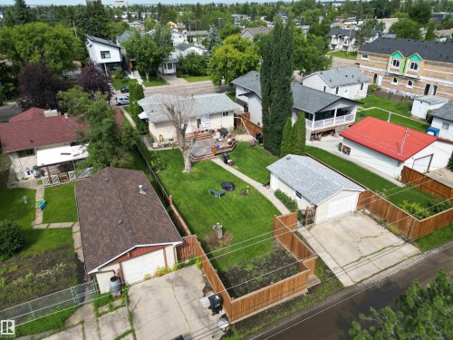 Rear detached garage with a concrete driveway, wood fencing, and a shingled roof - 10837 155 Street Nw, Edmonton, AB - Outdoor