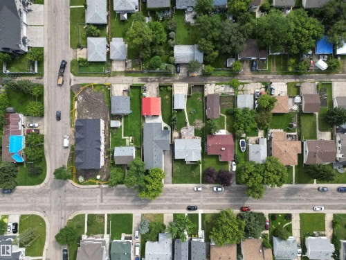 Newly constructed residence featuring a dark shingle roof and a light-toned exterior, situated on a corner lot - 10837 155 Street Nw, Edmonton, AB -  With View