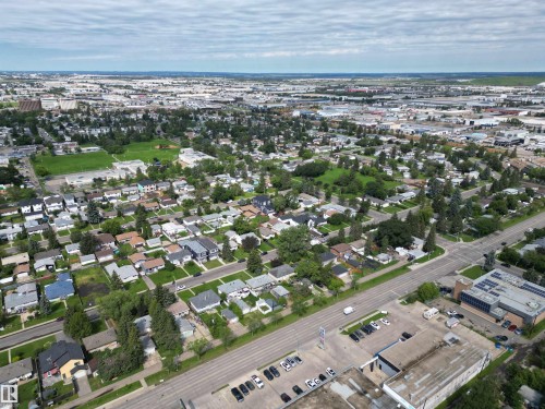 Expansive aerial showcasing a residential neighborhood with green spaces and a commercial corridor - 10837 155 Street Nw, Edmonton, AB - Outdoor With View