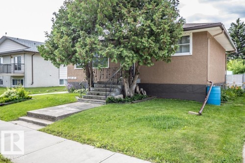 Traditional stucco exterior with white-framed windows - 5009 47 Ave, St. Paul Town, AB - Outdoor