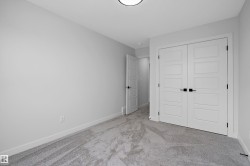 Light gray carpeting, white walls, and a flush-mounted ceiling light fixture - 
