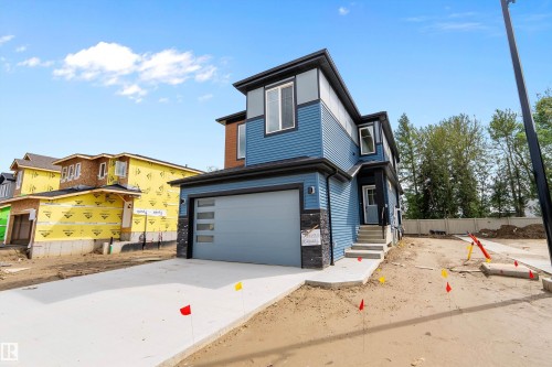 Contemporary exterior with blue siding and stone accents - 1737 Crossbill Loop Nw, Edmonton, AB - Outdoor